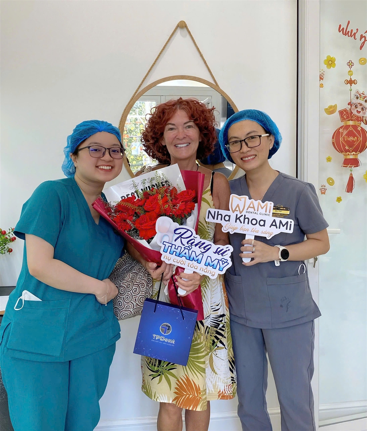 Ciara celebrating her new smile with the dedicated medical team at AMi Dental Clinic